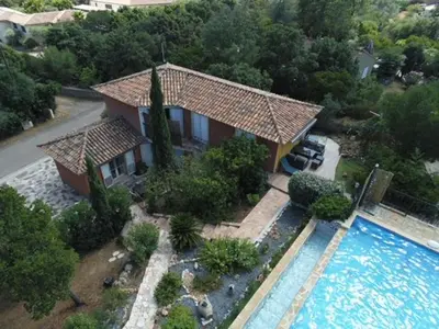 an aerial view of a house with a swimming pool at Cap Martin. in Lecci