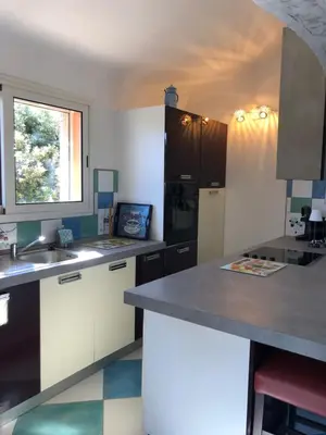 a kitchen with a sink and a counter top at Cap Martin. in Lecci