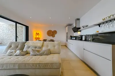 a living room with a couch and a kitchen at Le Galatée, T3 luxe in Porticcio