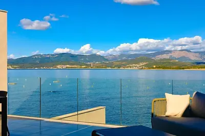 a room with a view of a large body of water at Le Galatée ,T2 luxe pieds dans l'eau in Porticcio