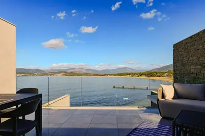 a living room with a view of the water at Le Galatée ,T2 luxe pieds dans l'eau in Porticcio