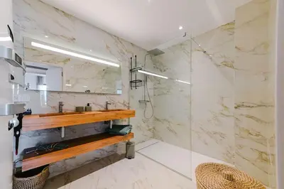 a bathroom with a sink and a mirror at Le Galatée ,T2 luxe pieds dans l'eau in Porticcio