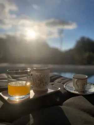 a tray with two cups and a candle on a table at Maison de campagne entre Ajaccio et Porticcio in Cauro