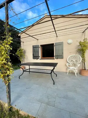 a ping pong table and a bench on a patio at Maison de campagne entre Ajaccio et Porticcio in Cauro