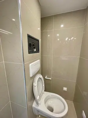a bathroom with a toilet with the lid up at Maison de campagne entre Ajaccio et Porticcio in Cauro