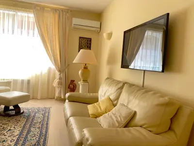 a living room with a couch and a window at T3 Ajaccio Sacrée Coeur in Ajaccio