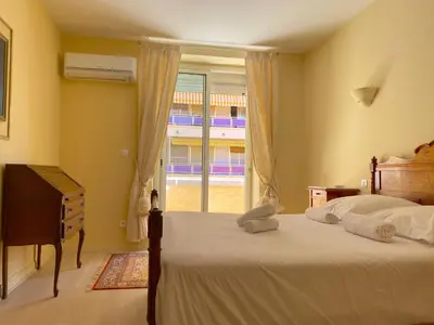 a bedroom with a large bed and a window at T3 Ajaccio Sacrée Coeur in Ajaccio