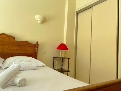 a bedroom with a bed with a sliding glass door at T3 Ajaccio Sacrée Coeur in Ajaccio