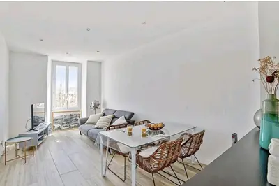 a living room with a table and a couch at Appartement Roi Jérôme - Hypercentre in Ajaccio