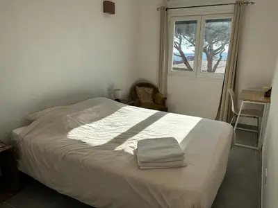 a bedroom with a bed with a towel on it at Jolie maison individuelle dans l’extrême sud in Monacia-dʼAullène