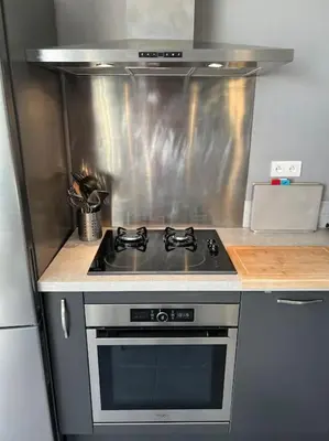 a kitchen with a stove and a sink at Jolie maison individuelle dans l’extrême sud in Monacia-dʼAullène