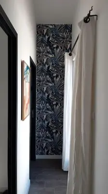 a hallway with a shower curtain and a wall at Porticcio- Duplex dans propriété privée in Cauro