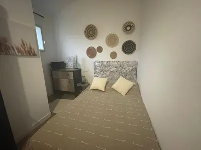 a bedroom with a bed with two pillows on it at Porticcio- Duplex dans propriété privée in Cauro