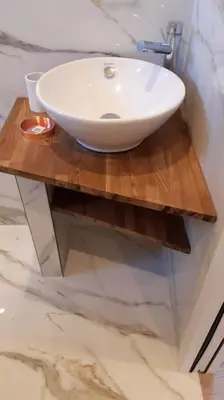 a white sink on a wooden table in a bathroom at Porticcio- Duplex dans propriété privée in Cauro