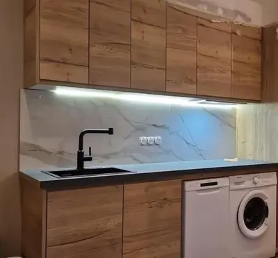 a kitchen with a sink and a washing machine at Porticcio- Duplex dans propriété privée in Cauro