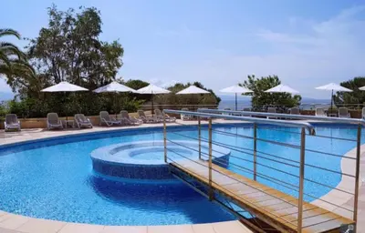 a swimming pool with chairs and umbrellas at Magnifique T2 vue Mer Sanguinaires in Ajaccio
