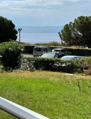 a group of cars parked in a parking lot at Magnifique T2 vue Mer Sanguinaires in Ajaccio
