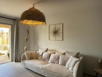 a living room with a white couch in a room at T4 Cala Rossa - 3 Ch - Piscine et Plage à pied in Lecci