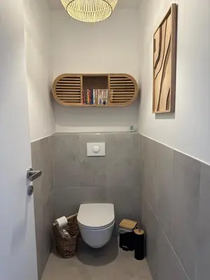 a small bathroom with a toilet and a fan at T4 Cala Rossa - 3 Ch - Piscine et Plage à pied in Lecci