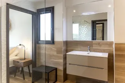 a bathroom with a sink and a mirror at Domaine d'Arca - Gauguin 12 - 6 pers in Porto-Vecchio