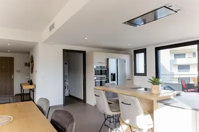 a kitchen and dining room with a table and chairs at Domaine d'Arca - Gauguin 12 - 6 pers in Porto-Vecchio
