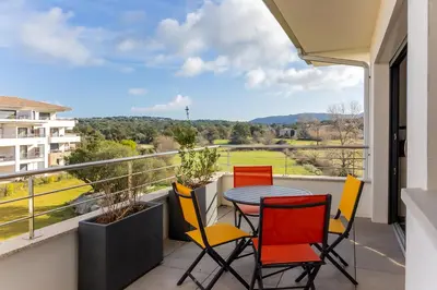 a balcony with a table and chairs and a view at Domaine d'Arca - Gauguin 12 - 6 pers in Porto-Vecchio