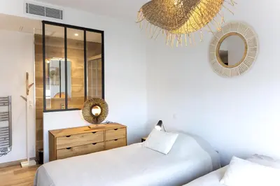 a bedroom with two beds and a mirror at Domaine d'Arca - Gauguin 12 - 6 pers in Porto-Vecchio