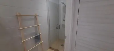 a bathroom with a shower and a glass door at RESIDENCE GIULIA in Propriano