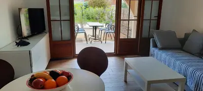 a living room with a bowl of fruit on a table at RESIDENCE GIULIA in Propriano