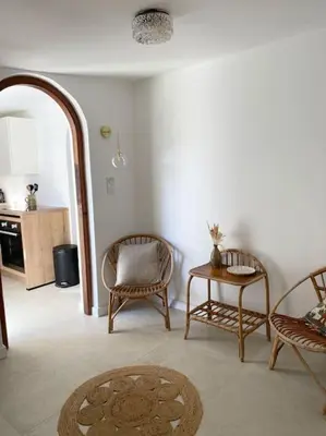 a living room with two chairs and a table at Maison à 150m de la plage naturiste, 2 chambres in Linguizzetta