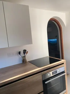 a kitchen with a stove and a counter top at Maison à 150m de la plage naturiste, 2 chambres in Linguizzetta