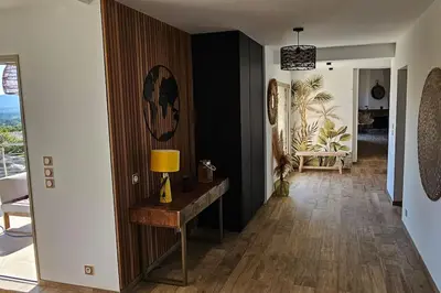 a hallway with a table with a lamp on it at villas-majos : Magnifique villa vue mer à 3 minutes des plages in Sainte-Lucie de Porto-Vecchio