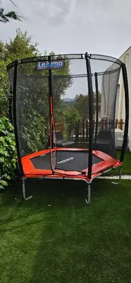 an empty trampoline on the grass in a yard at villas-majos : Magnifique villa vue mer à 3 minutes des plages in Sainte-Lucie de Porto-Vecchio
