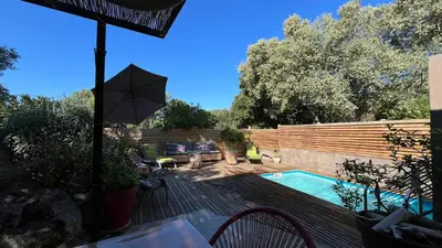 a backyard with a swimming pool and a wooden deck at Villa A Liccia piscine 4pers proche Ville et Port in Porto-Vecchio