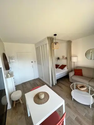 a living room with a couch and a table at Appartement ensoleillé à Ajaccio in Ajaccio