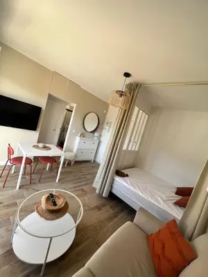 a living room with a bed and a table at Appartement ensoleillé à Ajaccio in Ajaccio