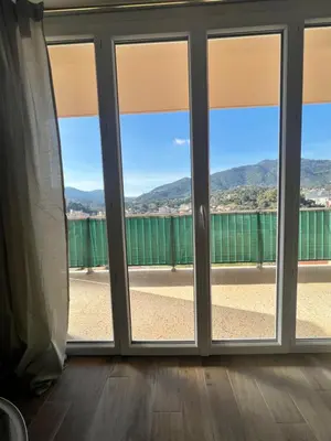 a window with views of the mountains at Appartement ensoleillé à Ajaccio in Ajaccio