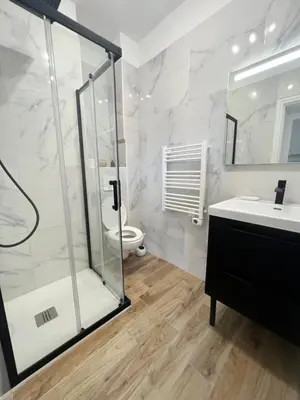 a bathroom with a shower and a sink and a toilet at Appartement ensoleillé à Ajaccio in Ajaccio