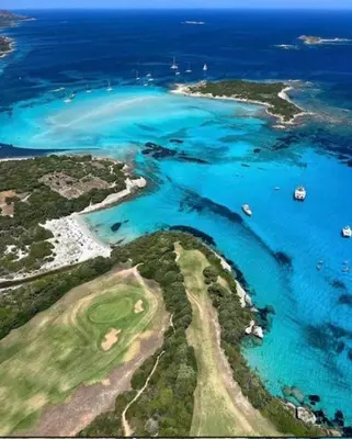 an aerial view of a beach with boats in the water at Tamaricciu di cala rossa in Lecci