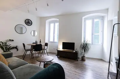 a living room with a couch and a table at Cocooning au cœur de la cité Impériale in Ajaccio