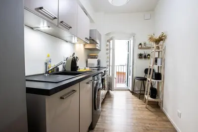 a kitchen with a sink and a stove at Cocooning au cœur de la cité Impériale in Ajaccio