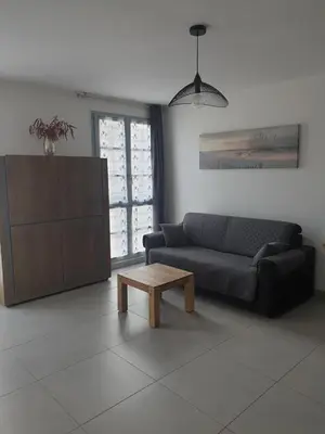 a living room with a couch and a coffee table at Appartement à deux pas du port de Bonifacio in Bonifacio