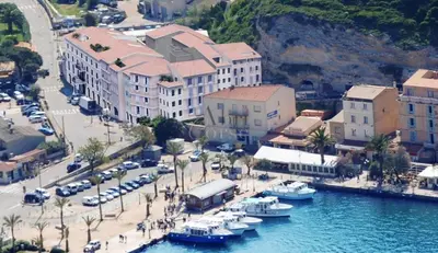 an aerial view of a town with boats in the water at Appartement à deux pas du port de Bonifacio in Bonifacio