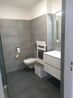 a bathroom with a toilet and a sink at Appartement à deux pas du port de Bonifacio in Bonifacio