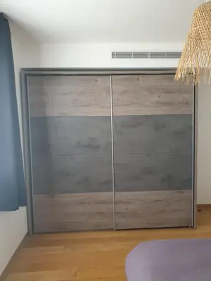 a sliding closet door with a fan on top at Appartement à deux pas du port de Bonifacio in Bonifacio