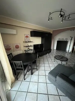 a living room with a table and a couch at Appartement T4 in Corte
