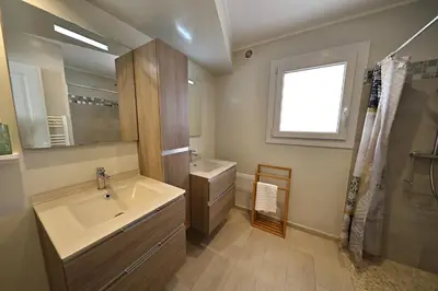 a bathroom with a sink and a mirror and a shower at L'alivi, Villa Prestige Avec Vue Panoramique in Figari