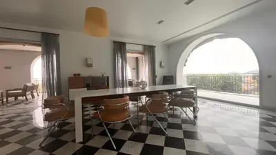 a dining room with a large table and chairs at VILLA DOLCE VITA in Ajaccio