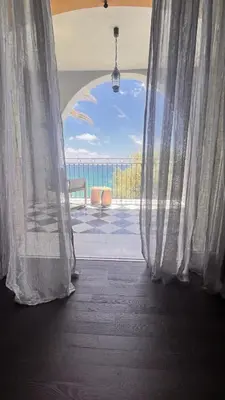 an open window with a view of the ocean at VILLA DOLCE VITA in Ajaccio