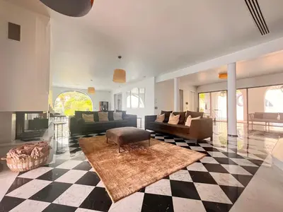 a living room with couches and a checkered floor at VILLA DOLCE VITA in Ajaccio